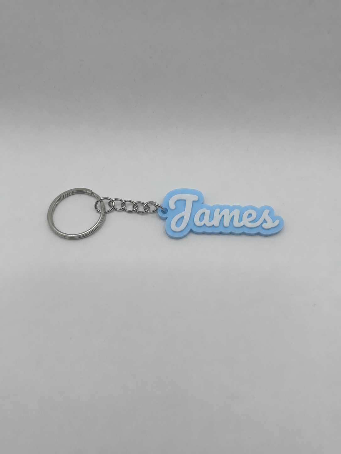 Personalized NiccieNacks name keychain in various colors, featuring custom name design on a durable metal keyring.
