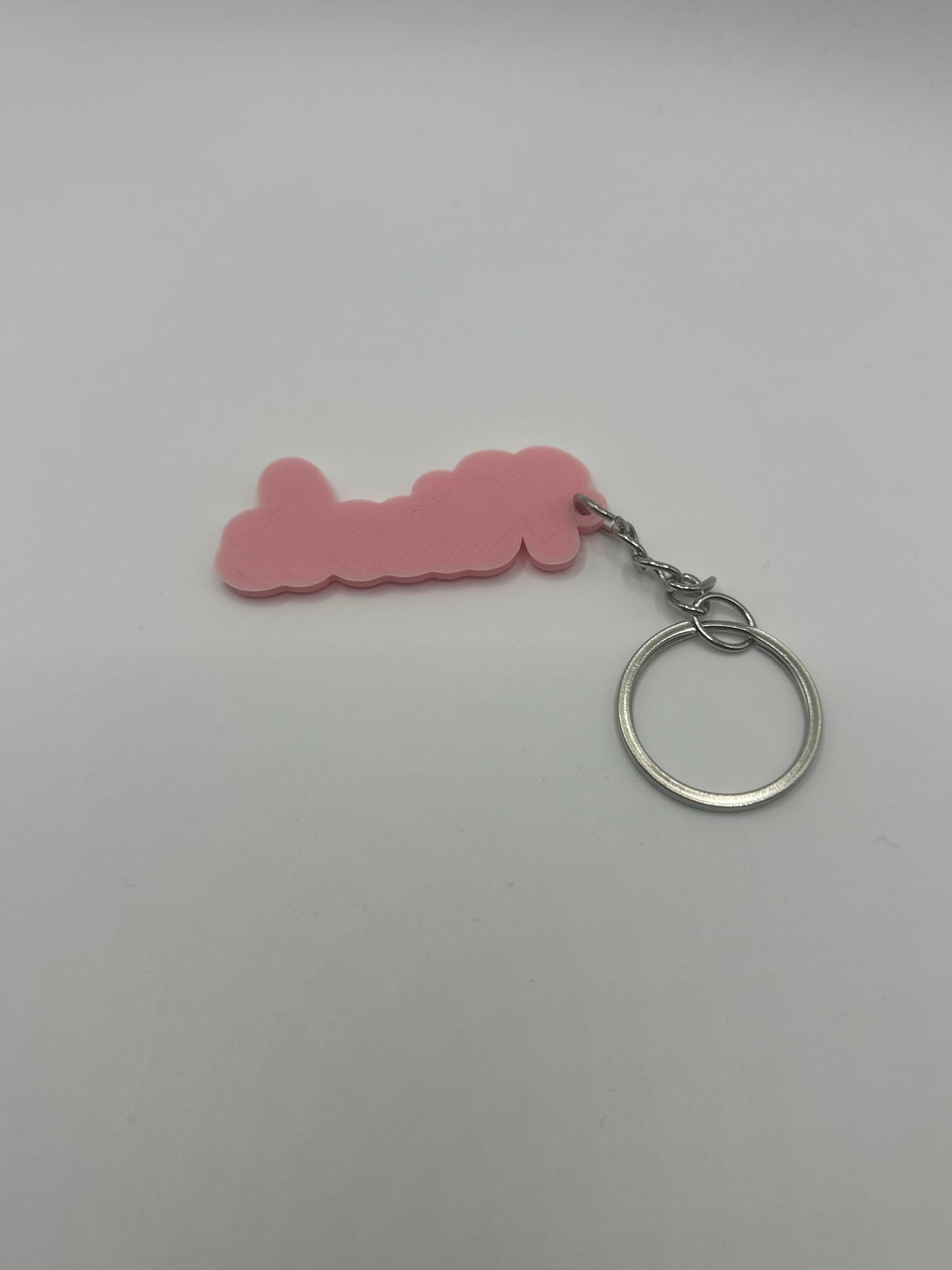 Personalized NiccieNacks keychain with custom name in various colors, featuring a close-up of the colorful metal keyring and engraved name.