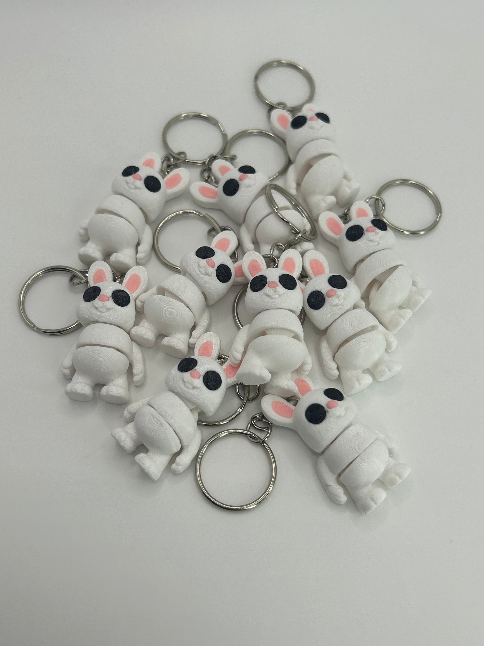 NiccieNacks Bunny Rabbit Articulated Flexi Wiggies toy or keychain showing a cute, flexible bunny figure with vibrant colors.