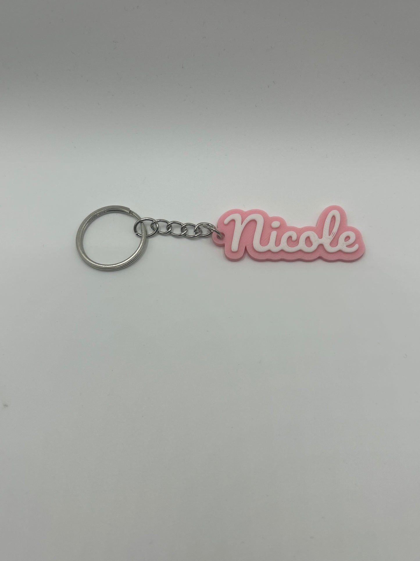 Personalized NiccieNacks name keychain in various colors featuring a custom engraved name on a small metal keyring.