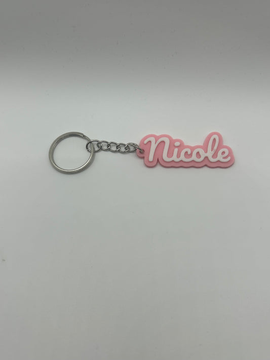 Personalized NiccieNacks name keychain in various colors featuring a custom engraved name on a small metal keyring.