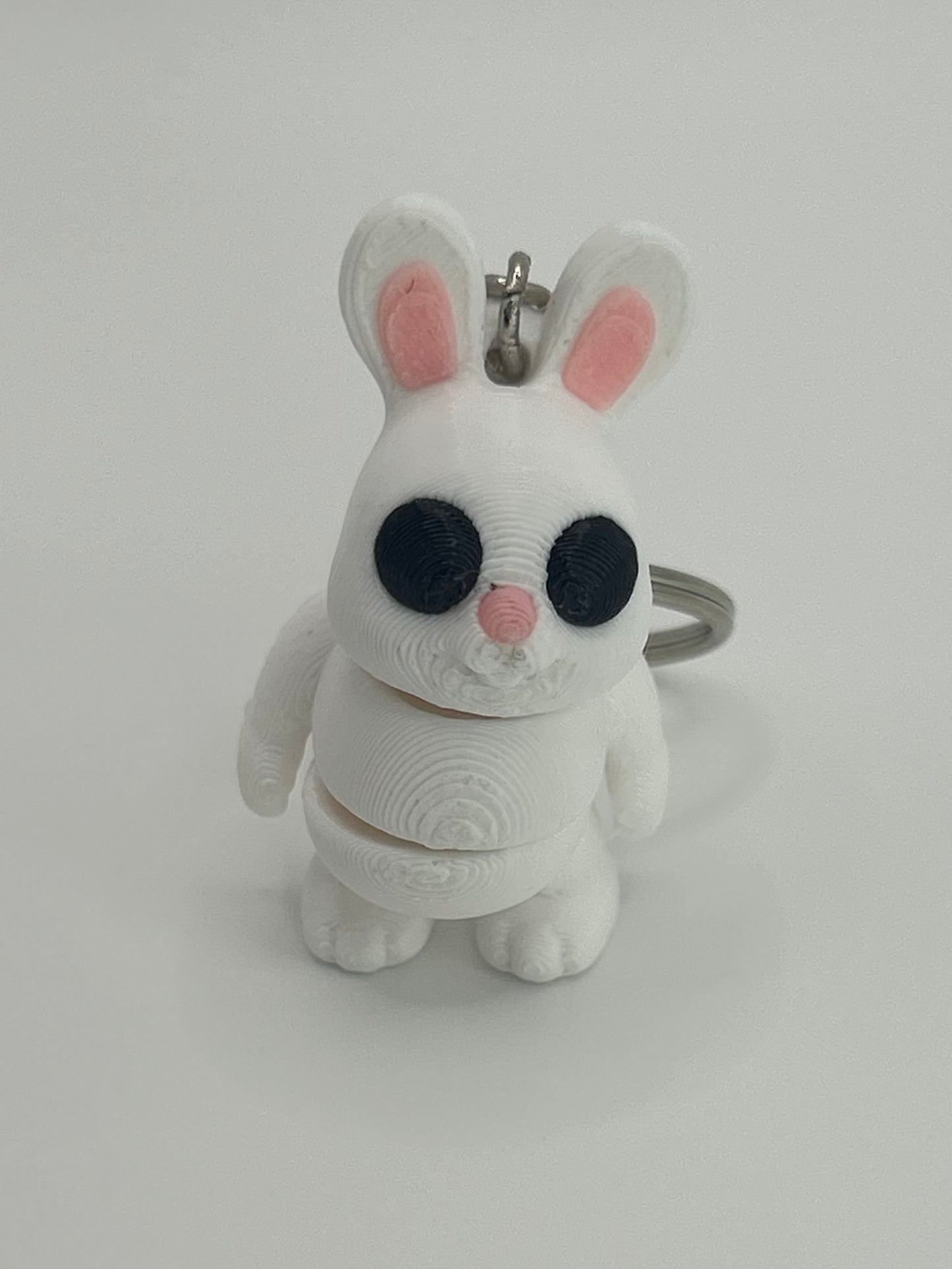 NiccieNacks Bunny Rabbit Articulated Flexi Wiggies toy keychain showing a cute, flexible bunny figure with jointed limbs.