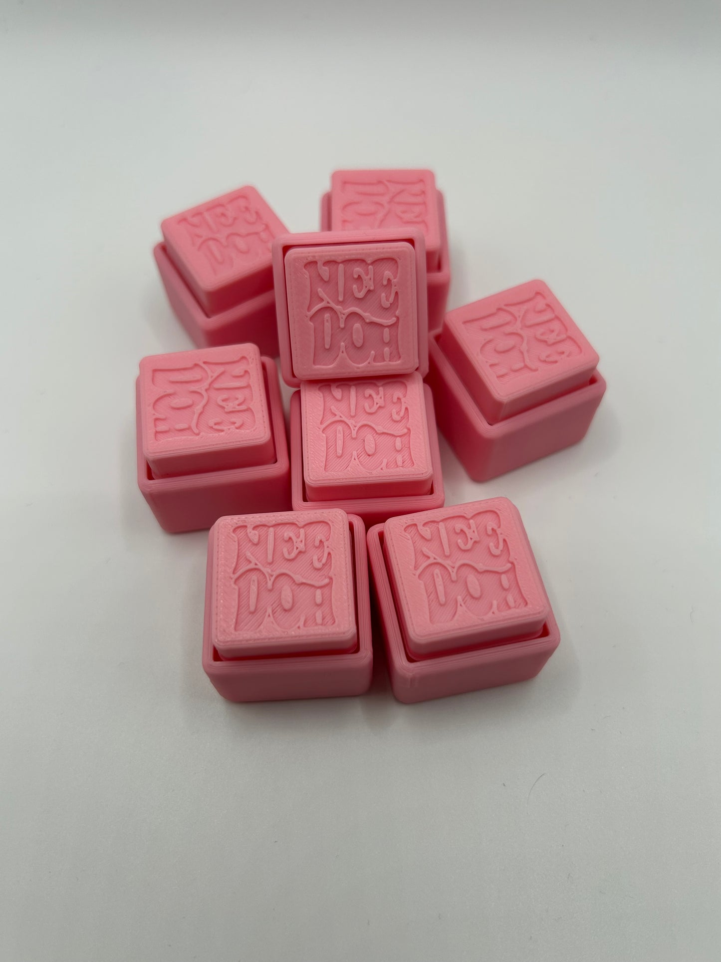Colorful NiccieNacks NeeDoh Style Fidget Clickers in various vibrant colors, designed for sensory and stress relief.