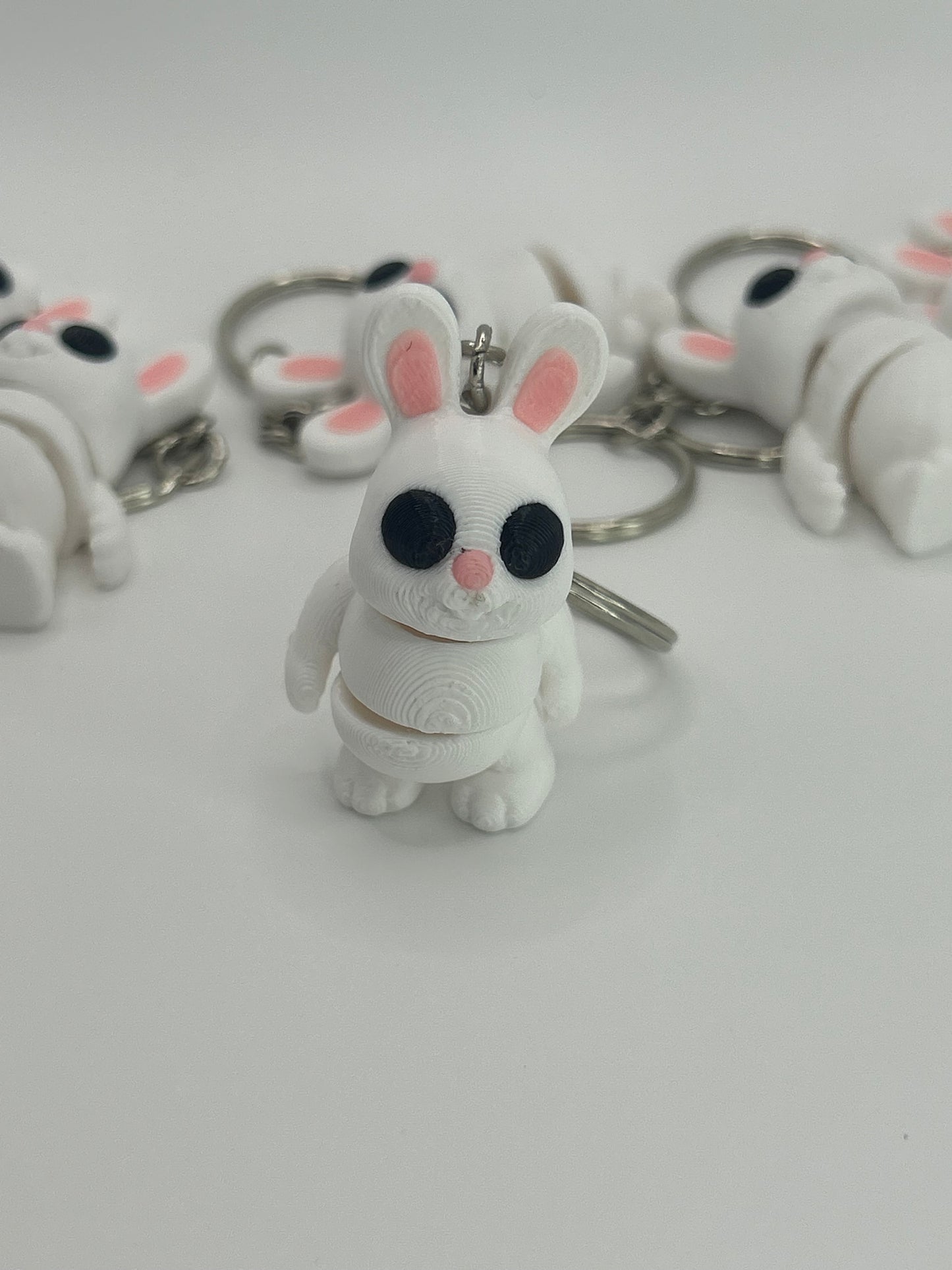 Colorful Bunny Rabbit Wiggies articulated toy and keychain by NiccieNacks, showing flexible limbs and playful design.