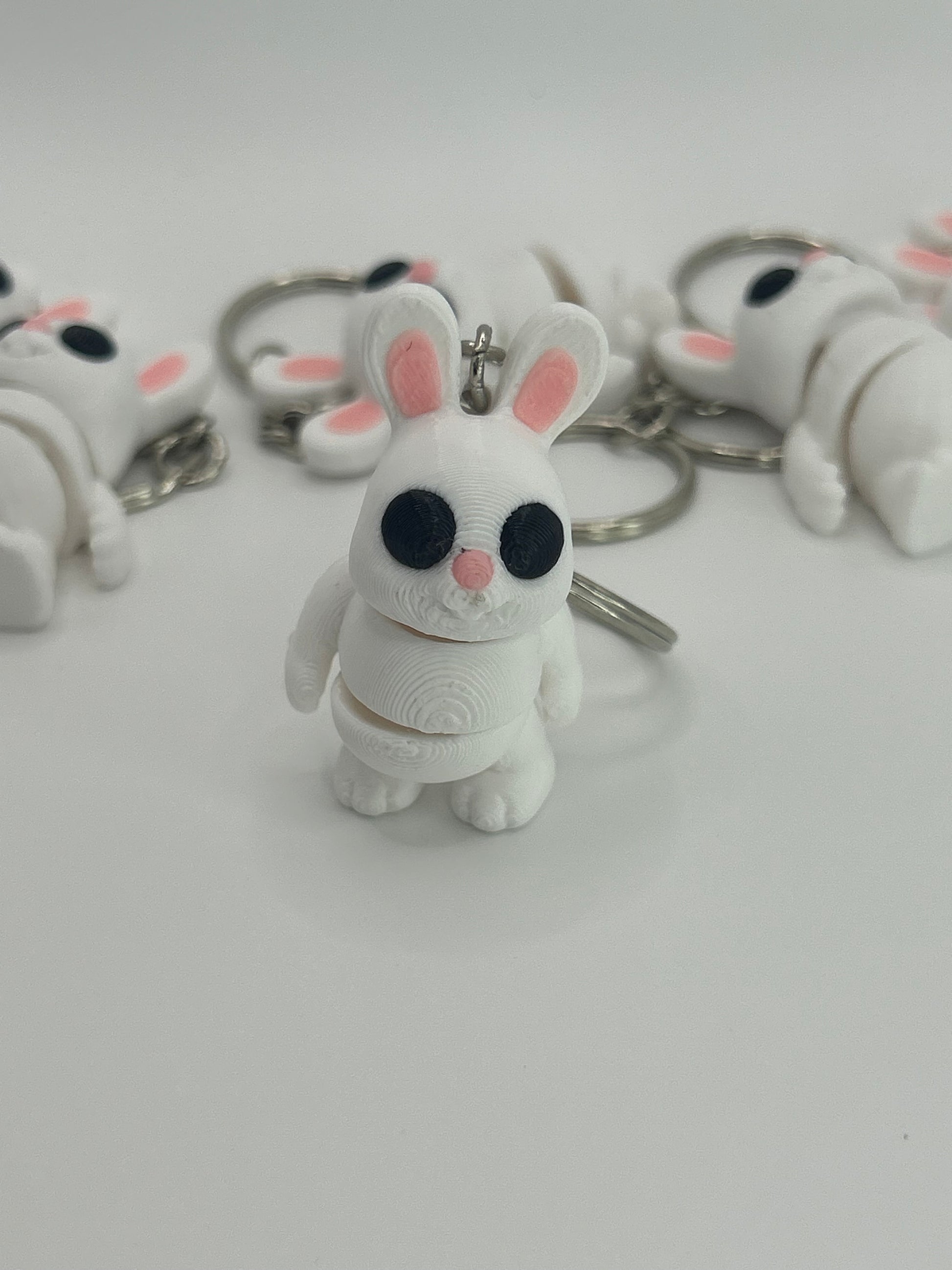 Colorful Bunny Rabbit Wiggies articulated toy and keychain by NiccieNacks, showing flexible limbs and playful design.