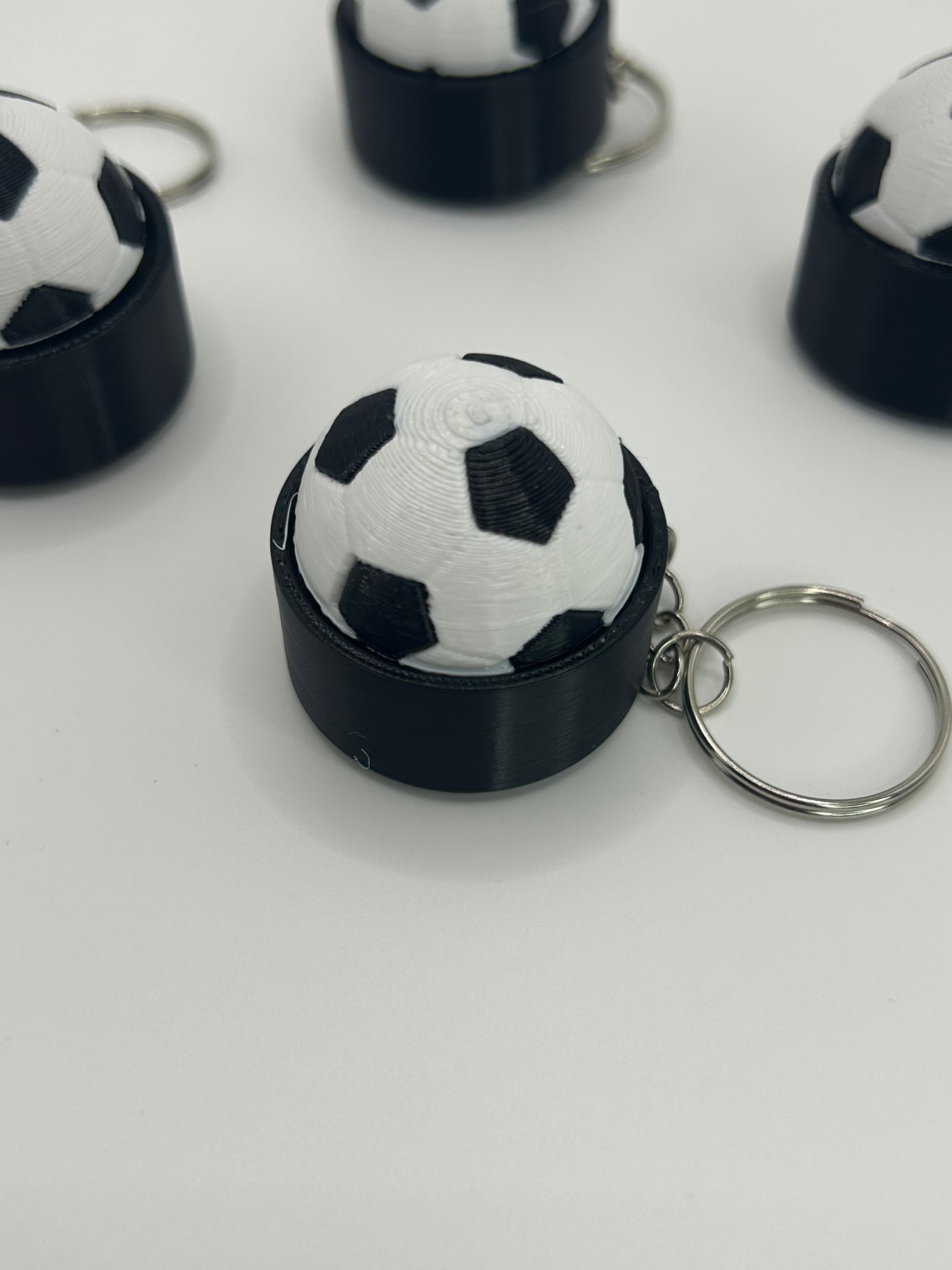 NiccieNacks World Cup football fidget clicker keyring with clickable football design, portable stress-relief accessory.