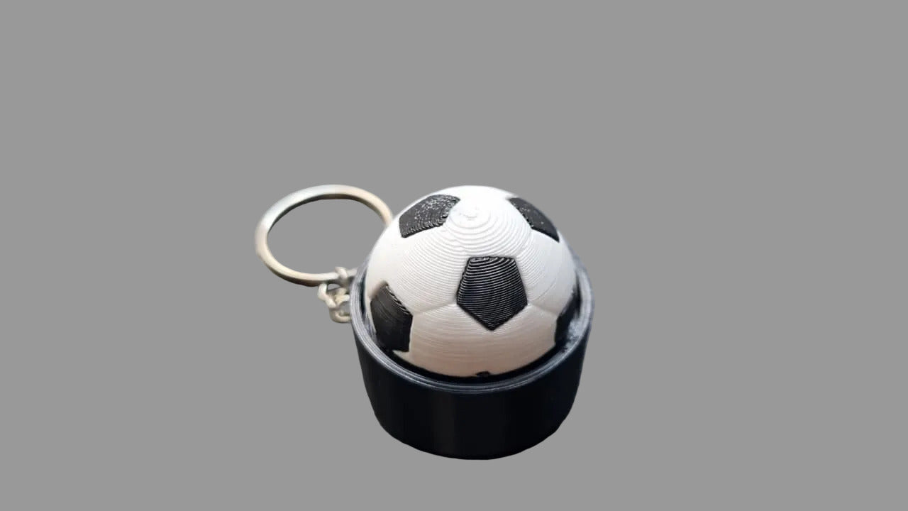 NiccieNacks World Cup football fidget clicker keyring with a miniature soccer ball design for tactile fun and stress relief.