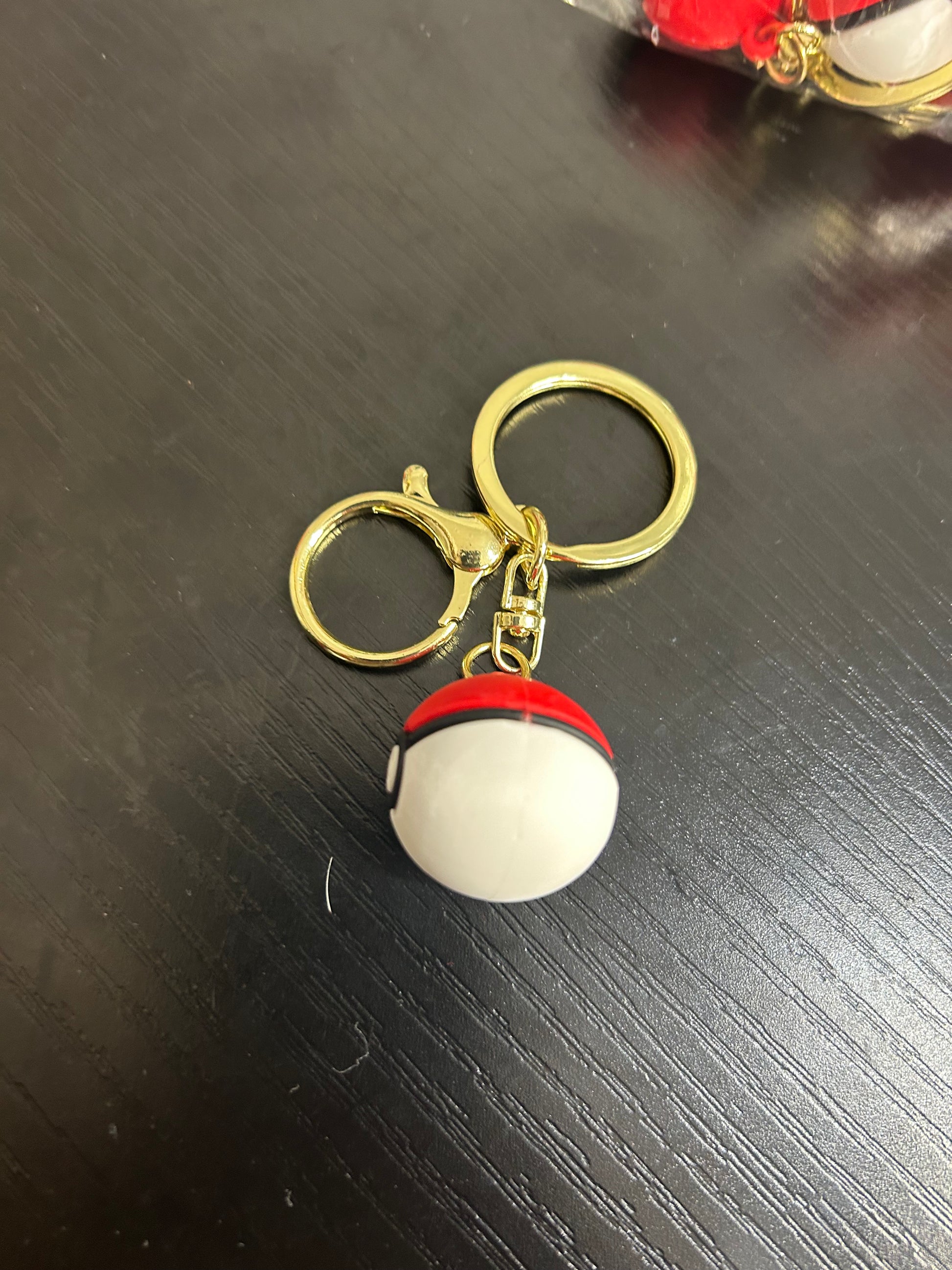 Pokemon Ball keyring by NiccieNacks featuring a colorful, round Pokemon-themed ball with a silver keyring attachment.