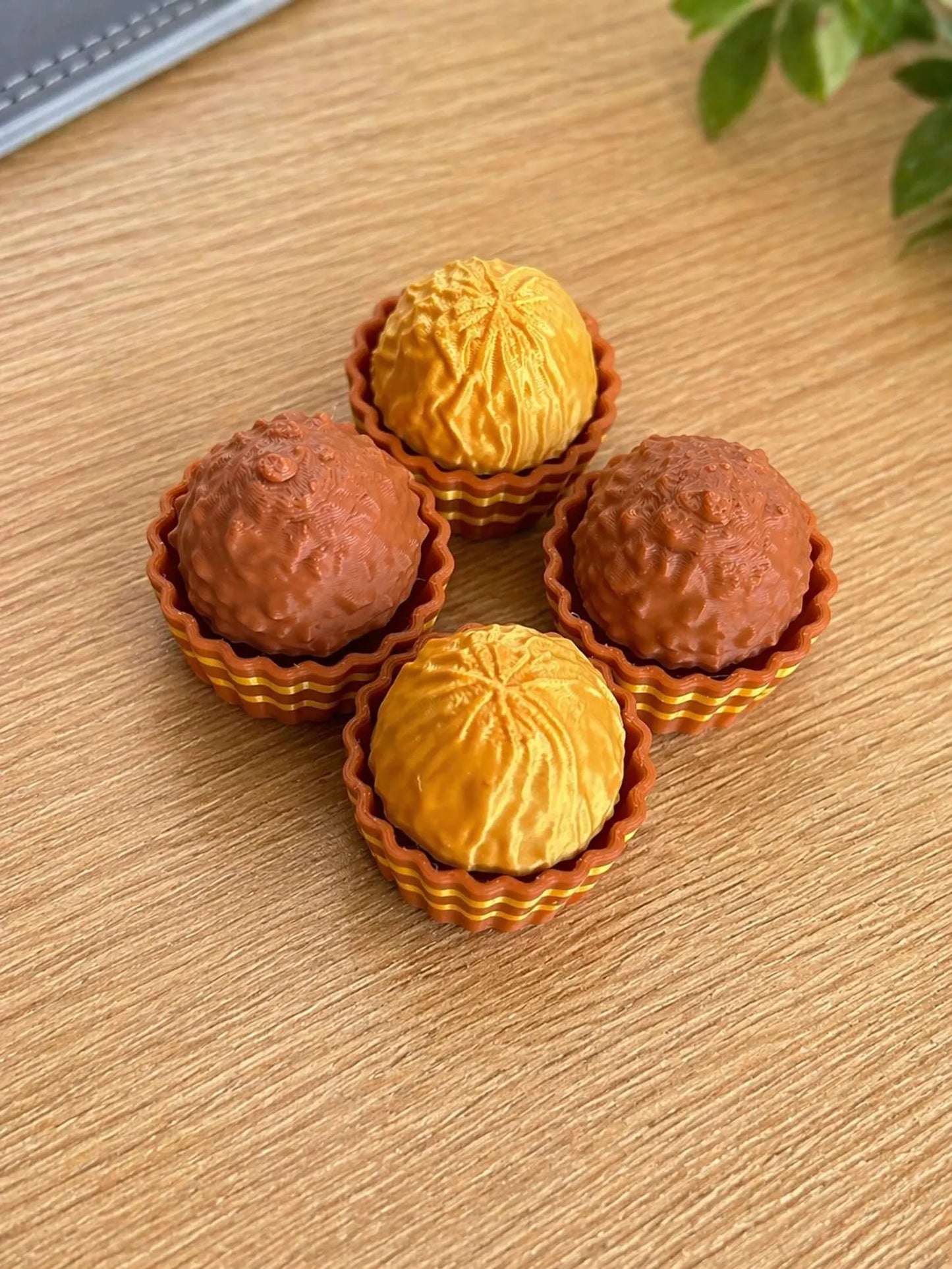 NiccieNacks Ferrero Rocher Fidget Toy Clicker showing the chocolate-inspired design and clickable surface for sensory fun.