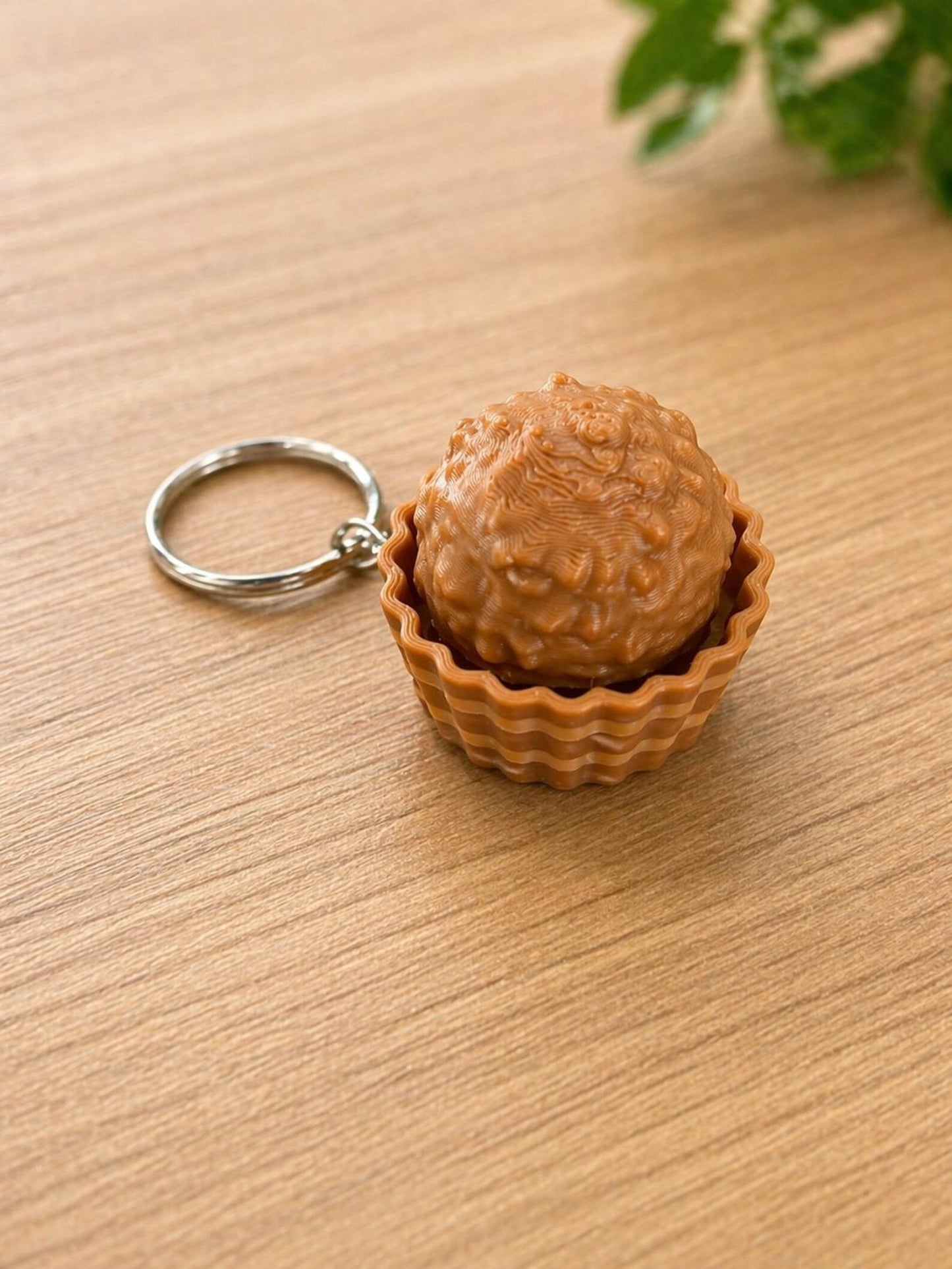 NiccieNacks Ferrero Rocher Fidget Toy Clicker with chocolate-inspired design, featuring a textured surface and clicker buttons.