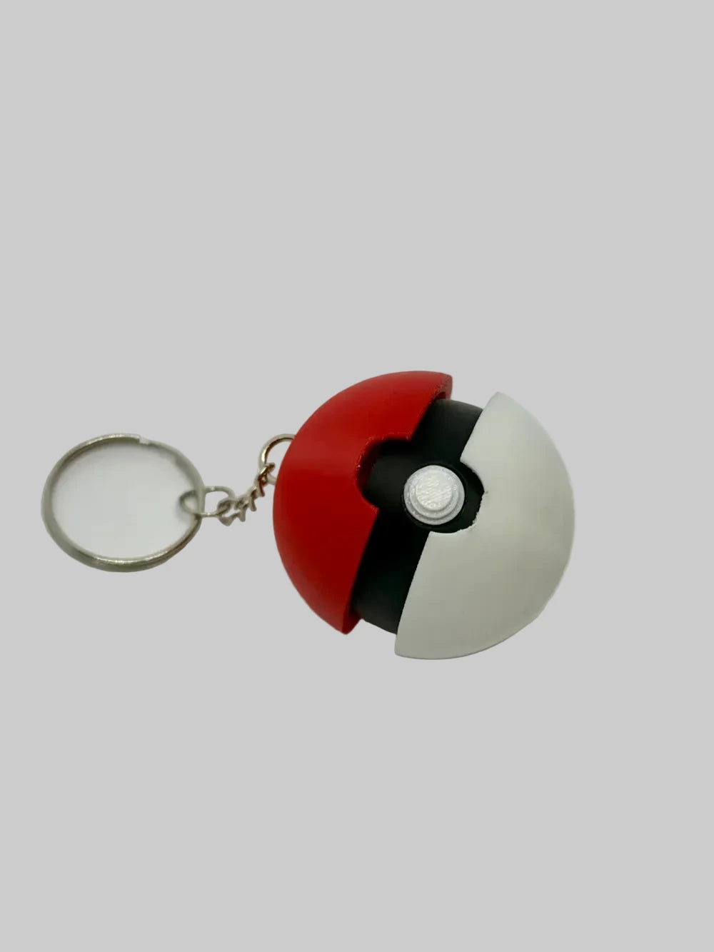 NiccieNacks Pokeball Fidget Clicker, small round handheld fidget toy with a Pokémon-inspired design and clicking mechanism.