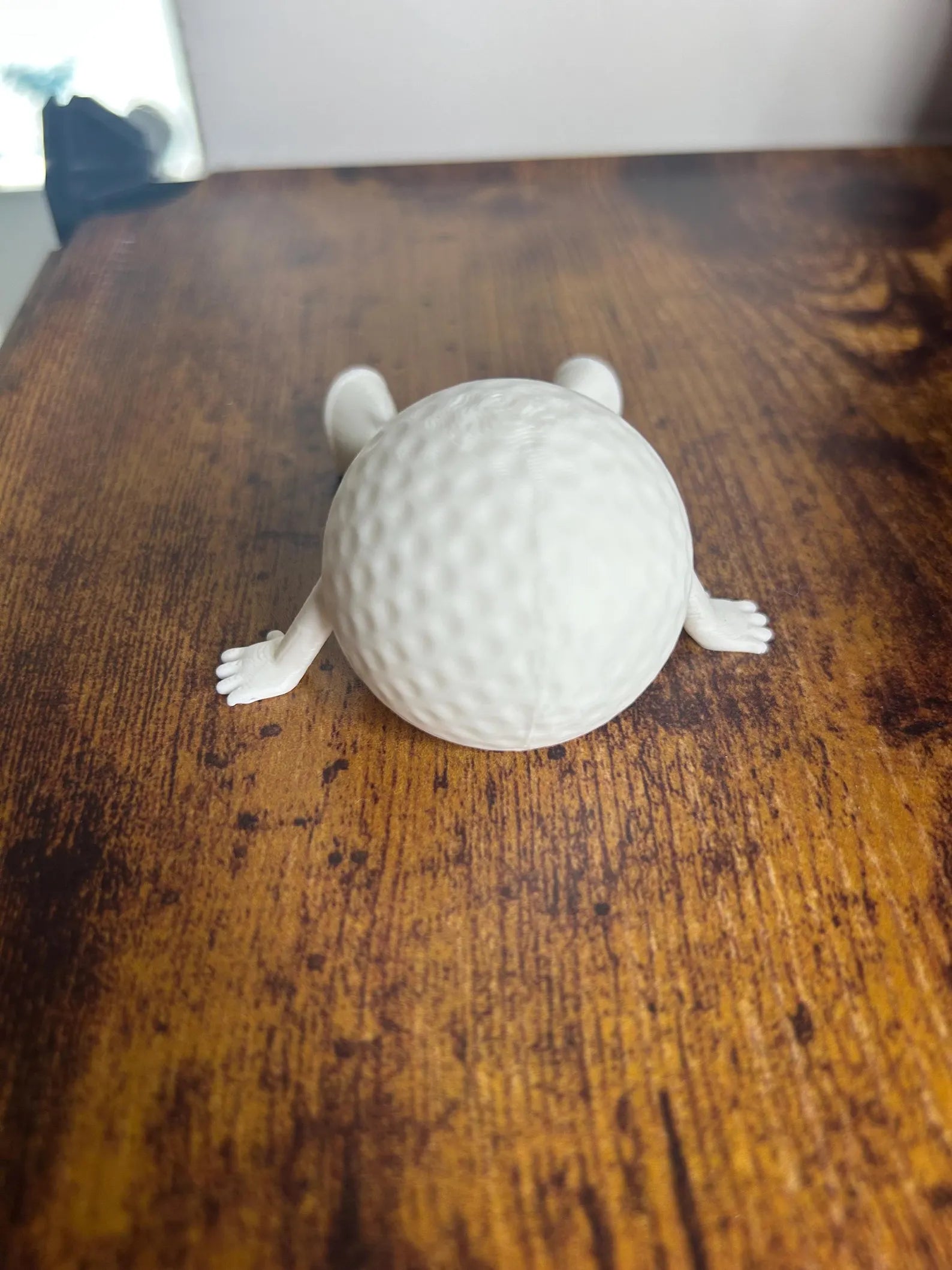 White articulated golf ball buddy toy ornament by NiccieNacks, featuring a playful design perfect for golf enthusiasts.