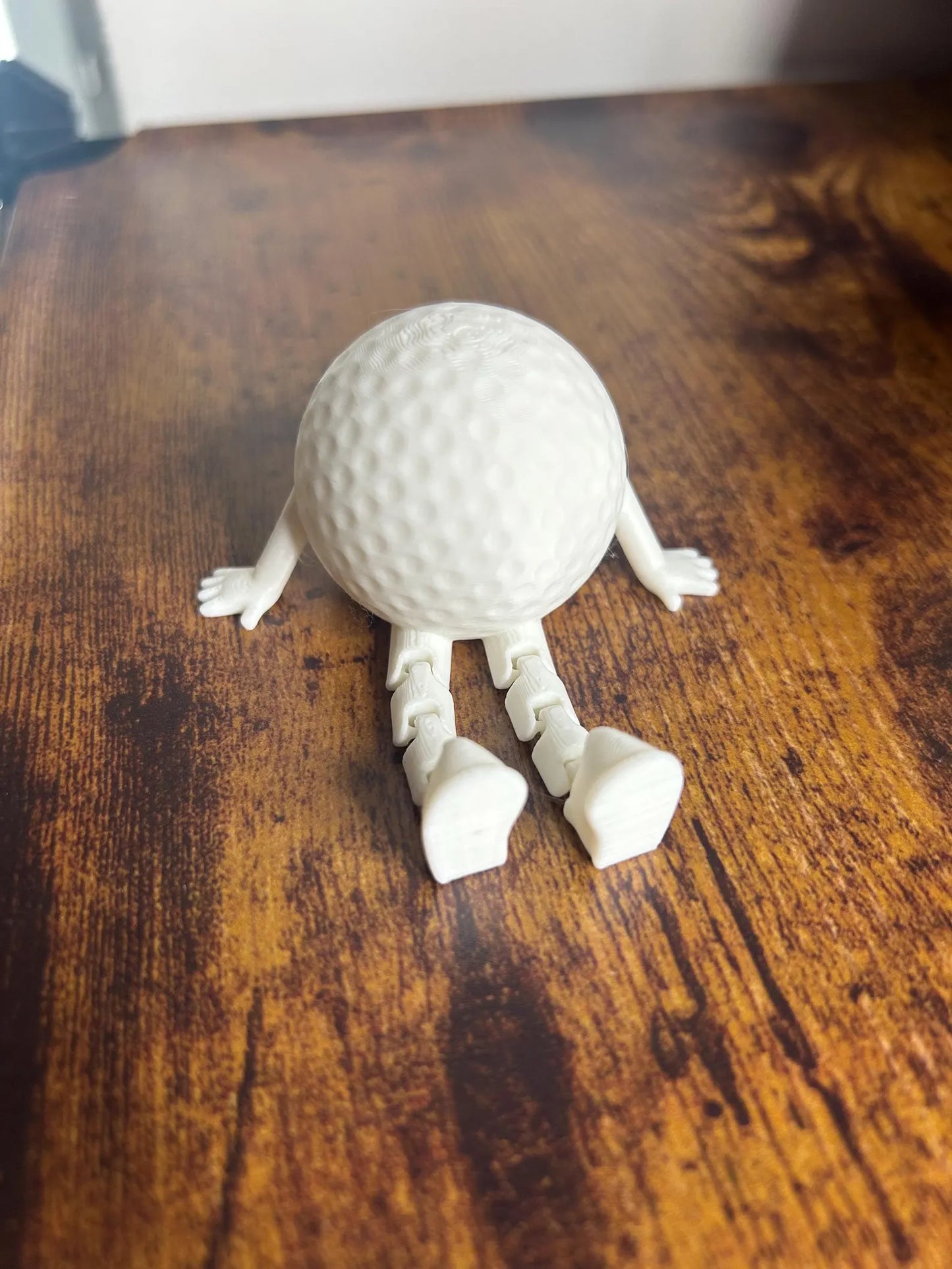 White articulated golf ball buddy toy ornament by NiccieNacks, featuring a playful golf-themed design and detailed craftsmanship.