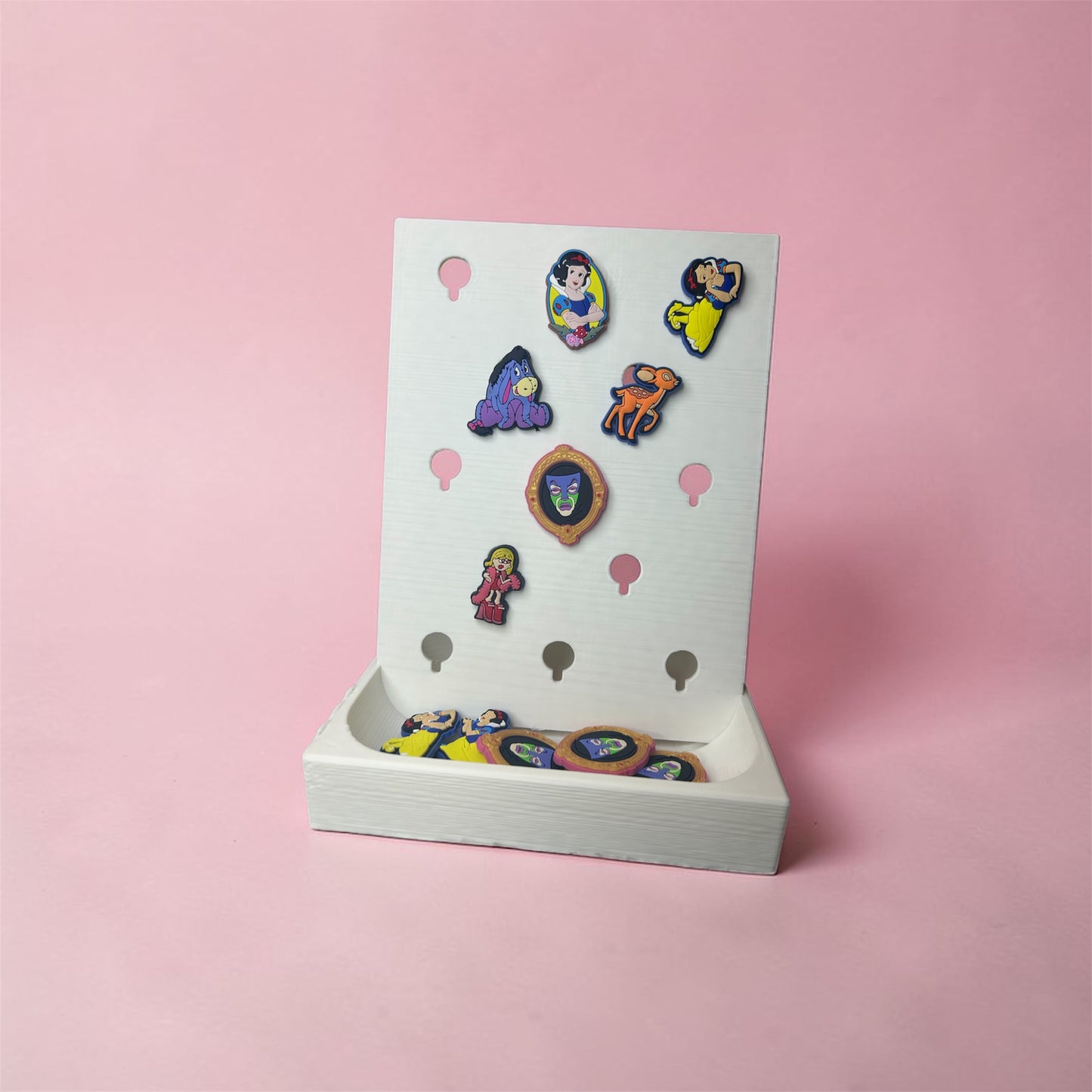 NiccieNacks Croc Jibbitz charm display stand shown with colorful charms on a home decor surface.