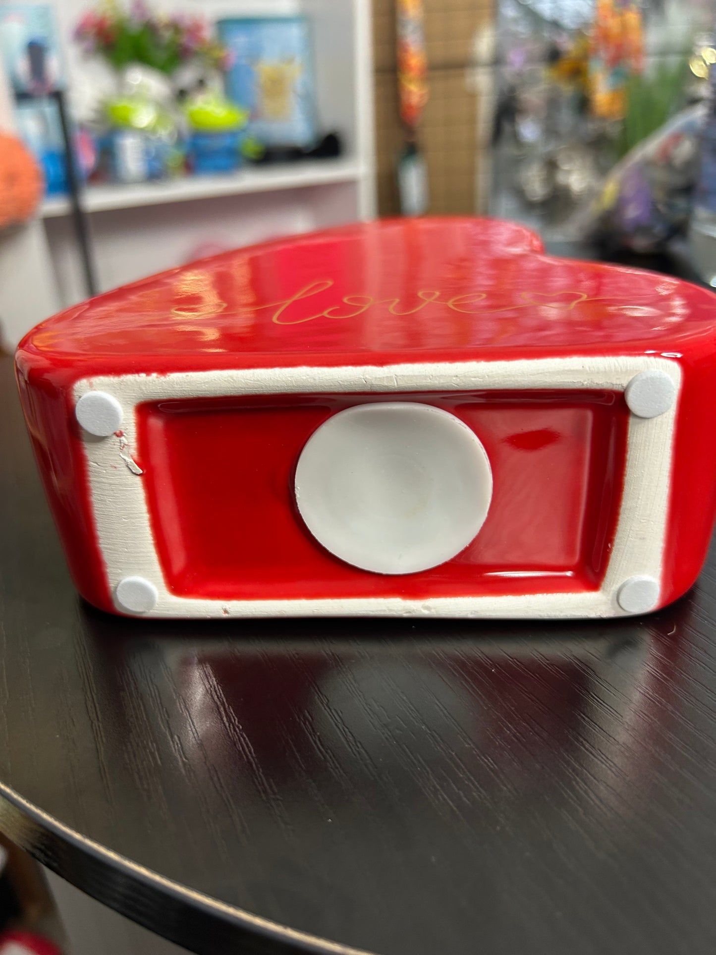 Red love heart ceramic money box for home use by NiccieNacks, featuring a charming heart design and coin slot on top.