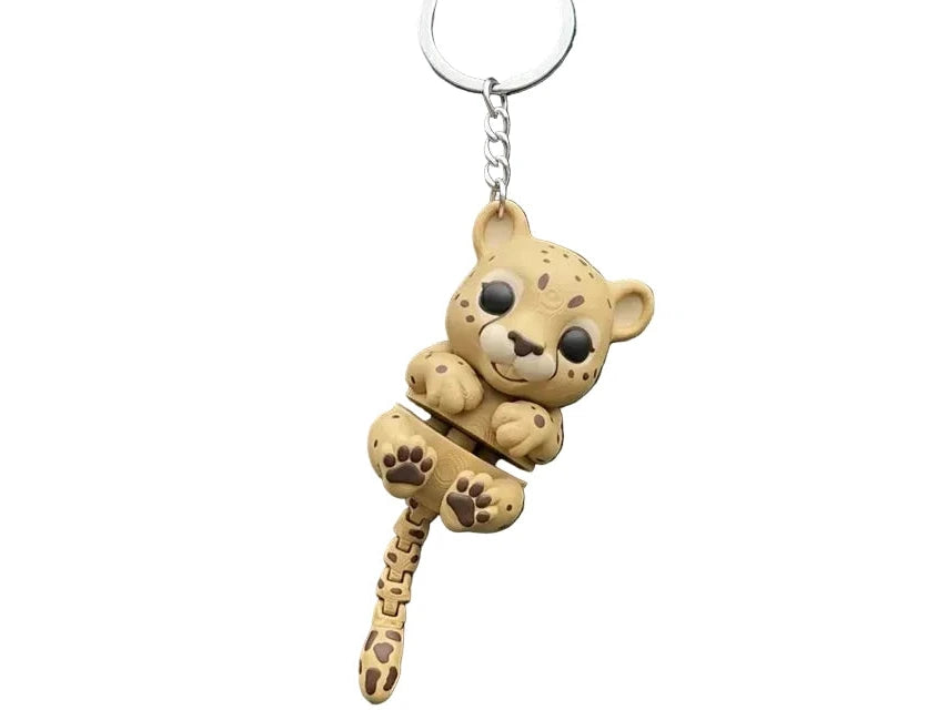 3D printed Flexi Cheetah Cub keychain by NiccieNacks featuring a colorful, flexible cheetah cub figure attached to a keyring.