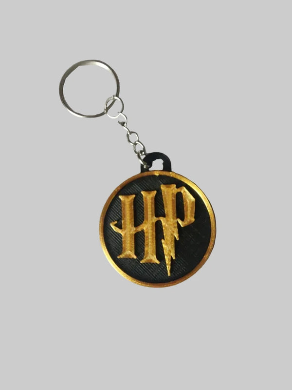 3D printed Harry Potter logo keyring by NiccieNacks, featuring a detailed Harry Potter emblem on a keychain.