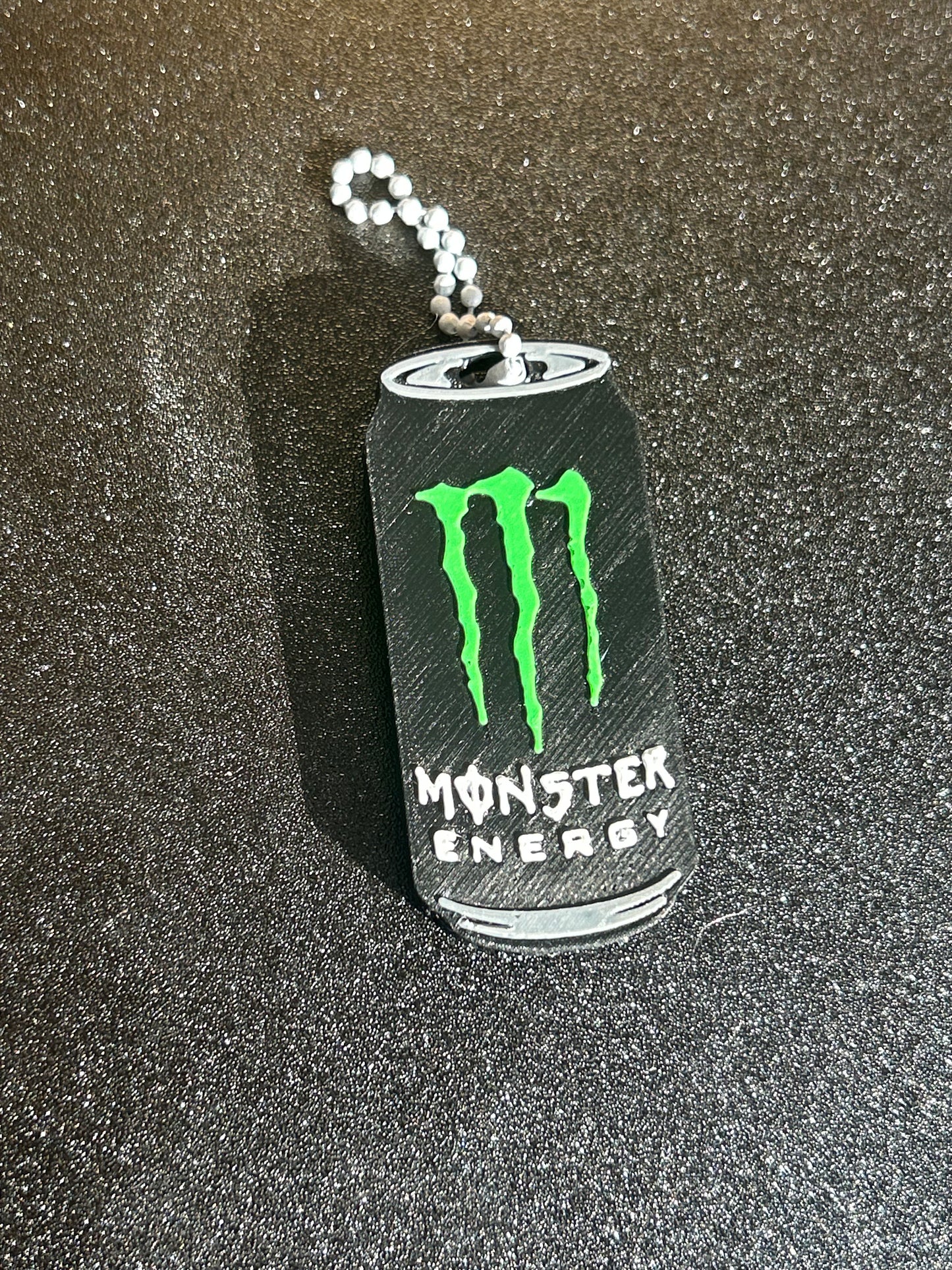 NiccieNacks Monster Energy can opener keychain with a compact, functional design featuring the iconic Monster Energy logo.