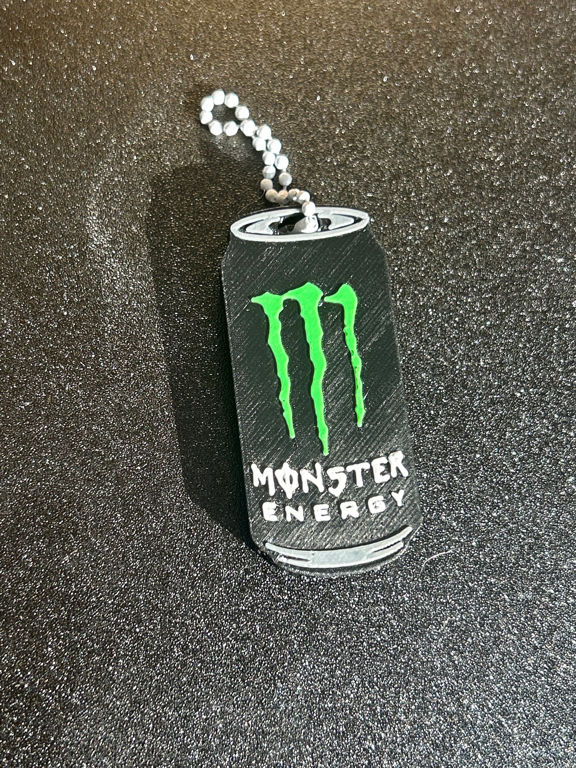 NiccieNacks Monster Energy can opener keychain with a compact, functional design featuring the iconic Monster Energy logo.