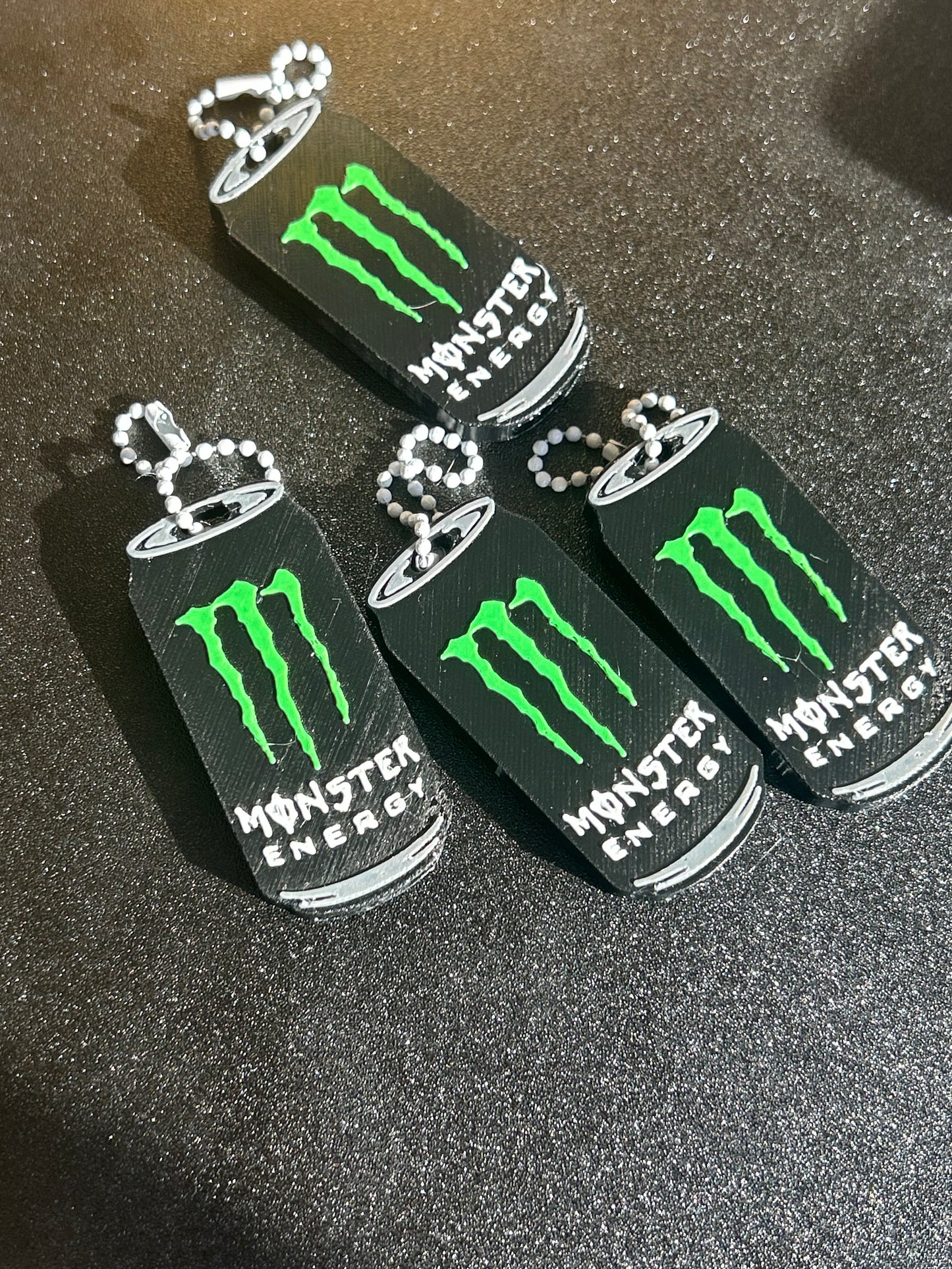 NiccieNacks Monster Energy can opener keyring, a compact keychain with a miniature can opener featuring the Monster Energy logo.