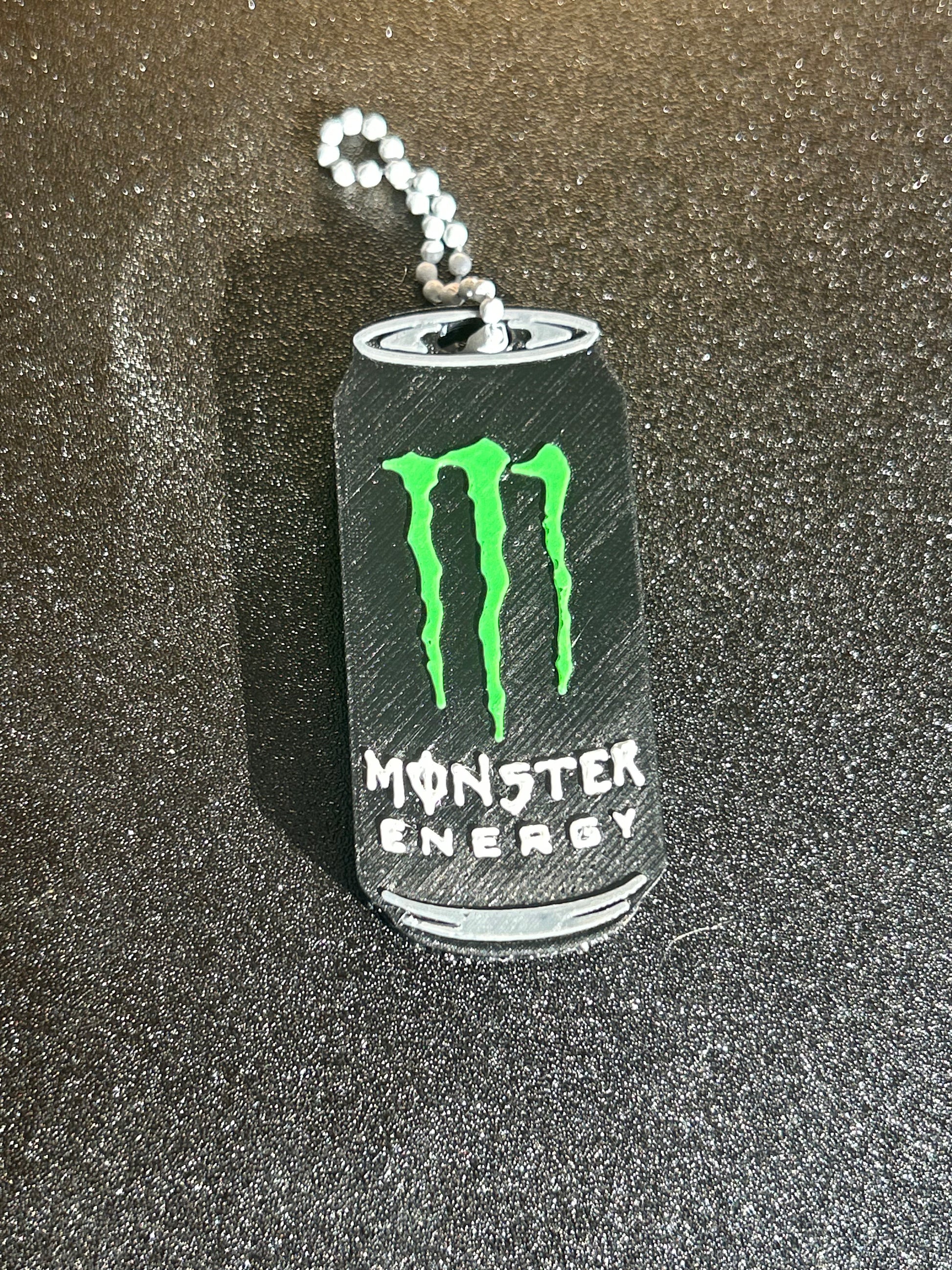 NiccieNacks Monster Energy can opener keyring, a compact keychain tool designed to open beverage cans easily.
