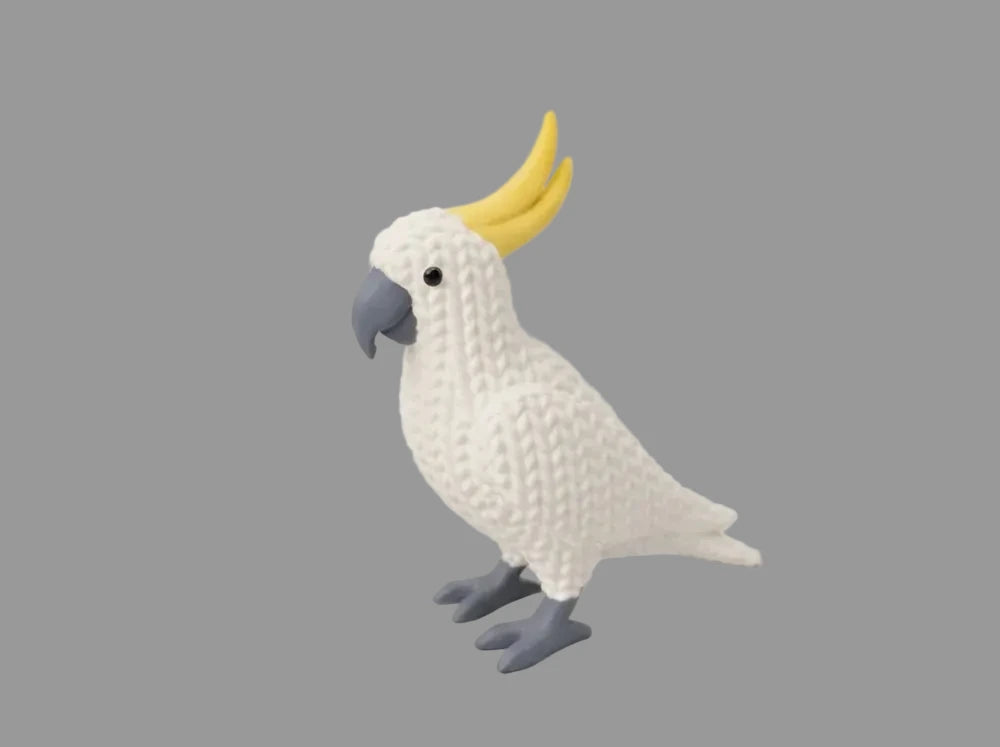 Knitted Cockatoo parrot toy model 3D print by NiccieNacks, showcasing detailed craftsmanship and colorful knitted feathers.