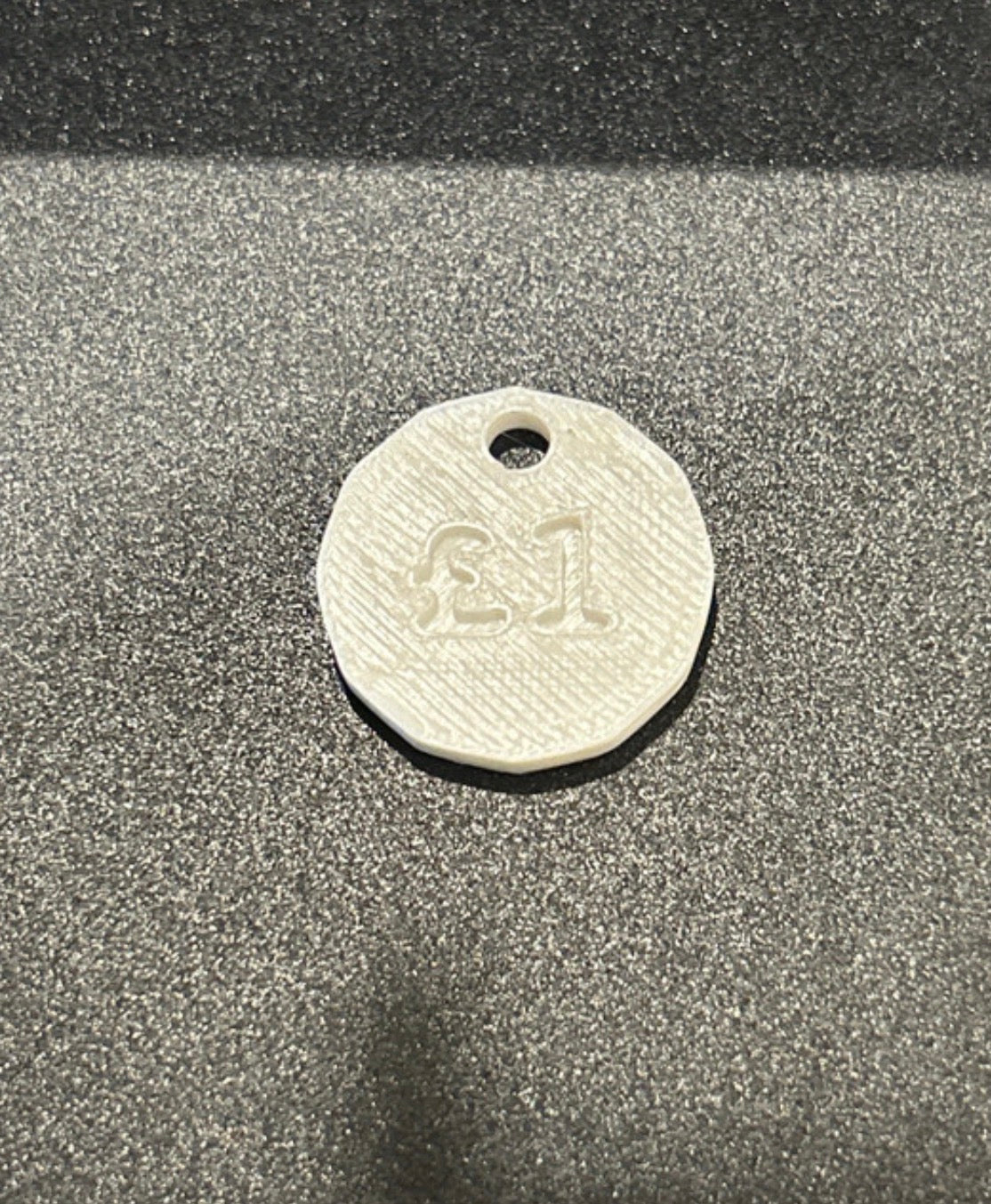 NiccieNacks UK £1 trolley coin token keyring with a circular metal design and keyring attachment, ideal for shopping carts.