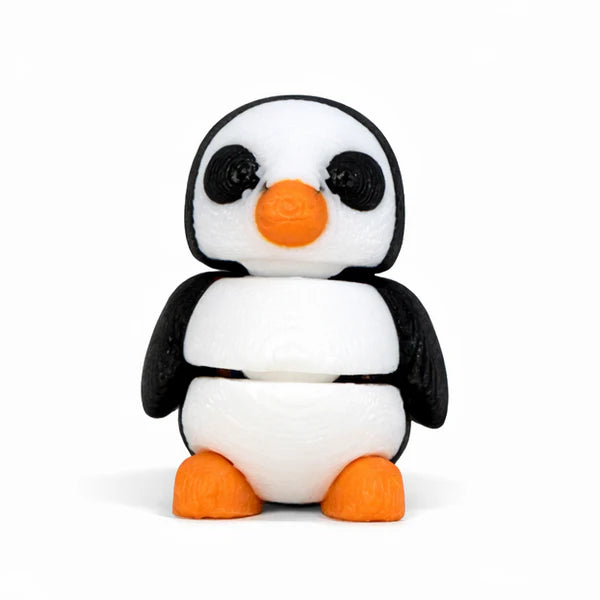 Small articulated penguin Wiggies toy by NiccieNacks with colorful, soft plastic features and jointed limbs for playful posing.